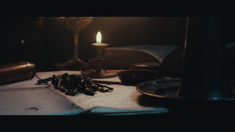 old keys on the table filled with documents and maps inside the sailing ship cabin