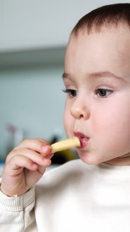 baby eating cheese stick