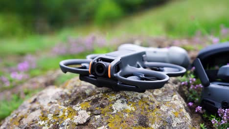 Small-FPV-drone-in-outdoor-environment-on-rock-with-lichen-crust,-Czechia