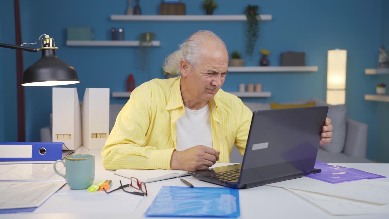 Home office worker old man has visual impairment problem.