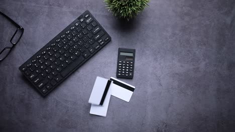office desk setup with keyboard, calculator, and credit cards