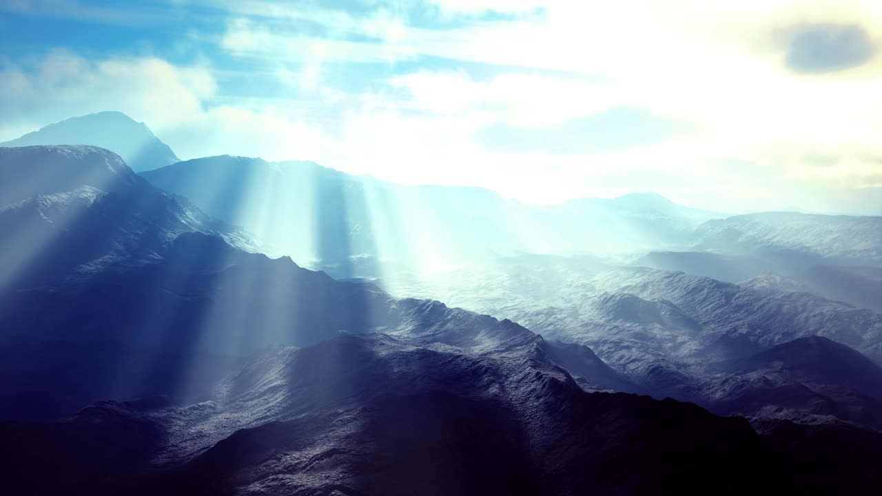 Majestic mountain landscape with ethereal light breaking through clouds