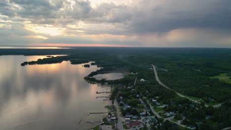 aerial sunset view of hessel michigan coastline and dramatic clouds, les cheneaux islands, michigan