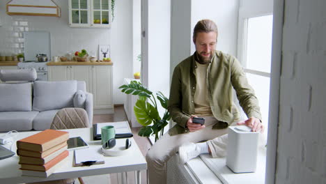 Man-sitting-on-the-windowsill