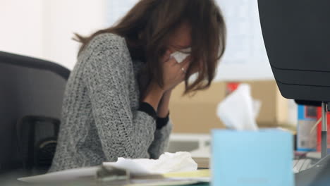 female office worker suffering with cold symptoms