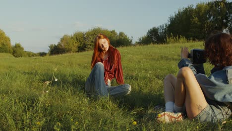 two friends taking photos in a field