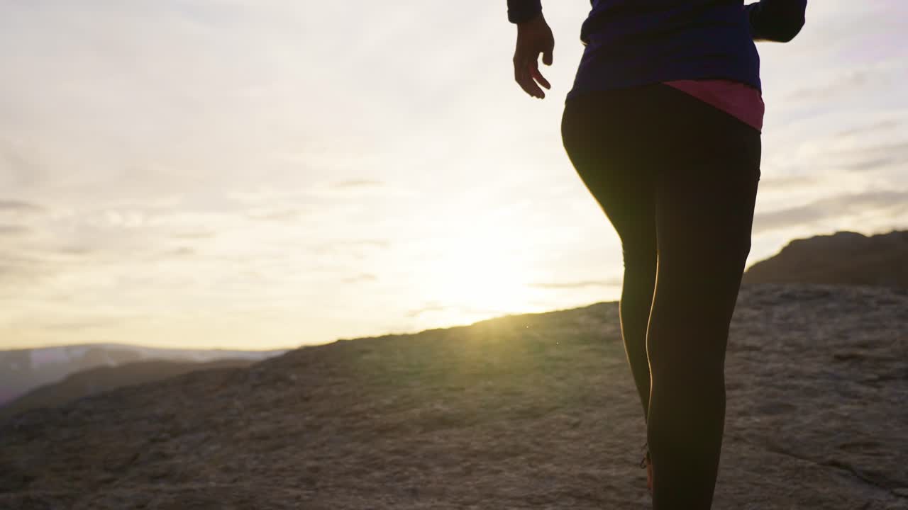 Jogger on mountain trail at sunset in Norway with peaceful and active feeling, Trolltunga