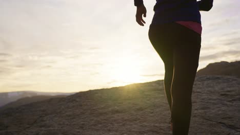 jogger on mountain trail at sunset in norway with peaceful and active feeling, trolltunga