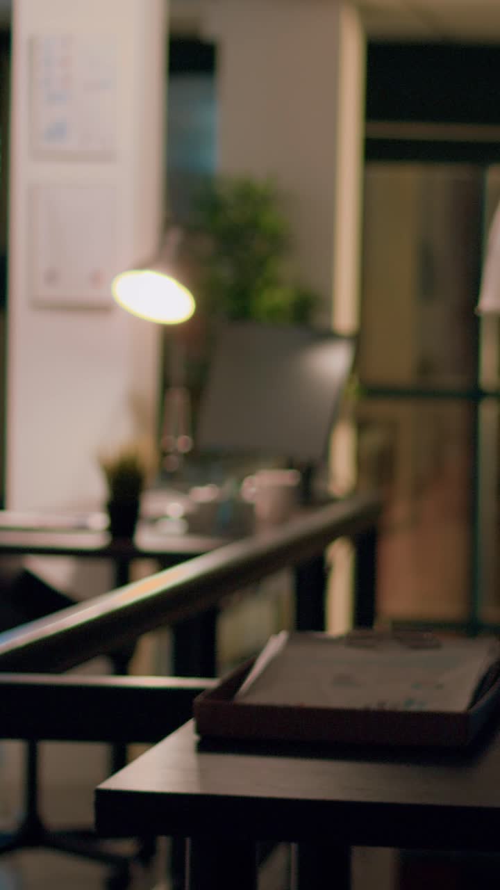 Vertical video Employee alone overnight in office