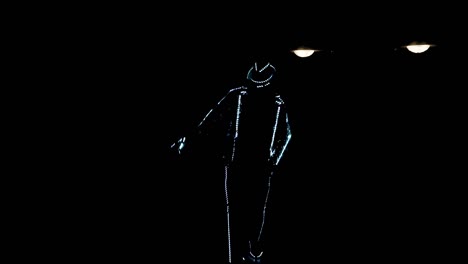 A-guy-in-an-LED-suit-dances-in-the-dark