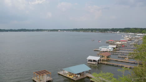 drone shot passing lake docks on a cloudy day