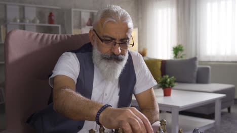 clever man playing chess alone at home, strategizing.