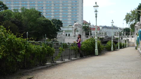 Asian-Woman-looking-from-Bridge-Covering-with-Scarf,-Slow-motion