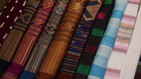 colorful-traditional-fabrics-for-sale-at-night-market-in-Luang-Prabang,-Laos-traveling-Southeast-Asia