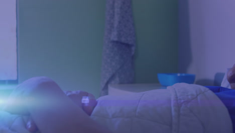 streaks of light against male patient lying on hospital bed