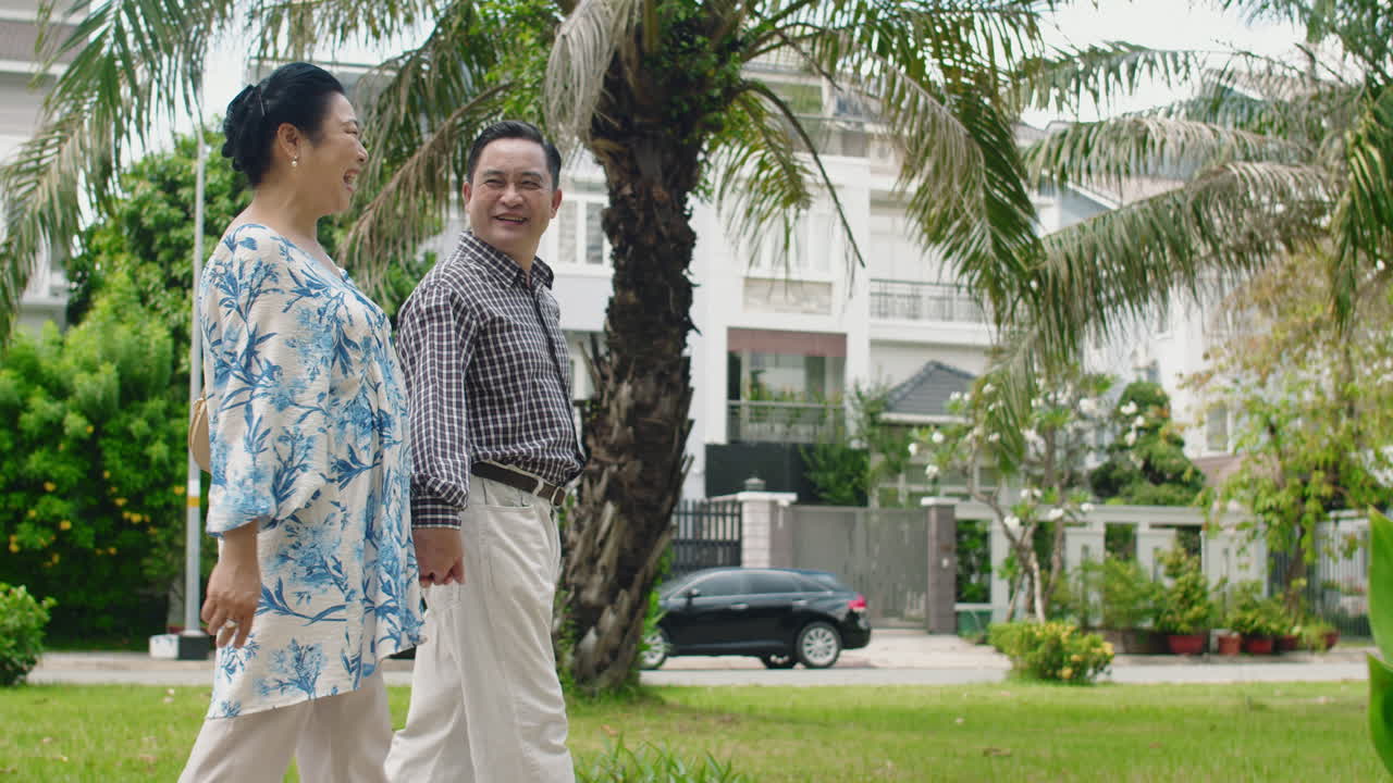 Mature Husband and Wife Walking on Street, Slow Motion