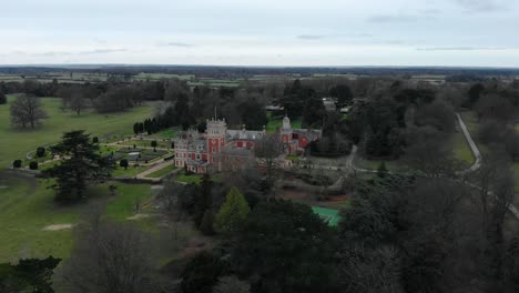 Aerial---Somerleyton-Hall-and-its-fields,-Somerleyton,-England,-wide-circle-shot