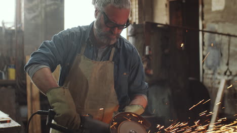 blacksmith using cutting disc at work