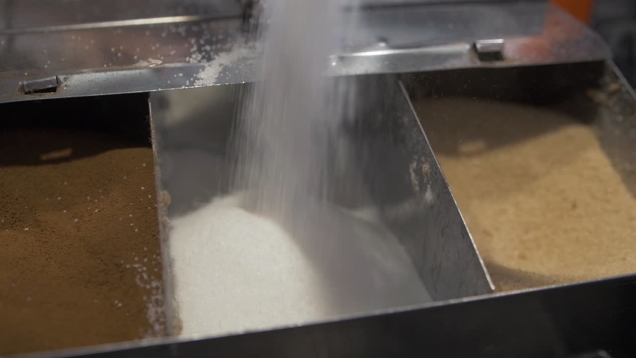 Static handheld shot falling sugar slow motion cinematic shallow depth of field