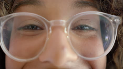 portrait of happy biracial female teenager with curly hair at home, slow motion