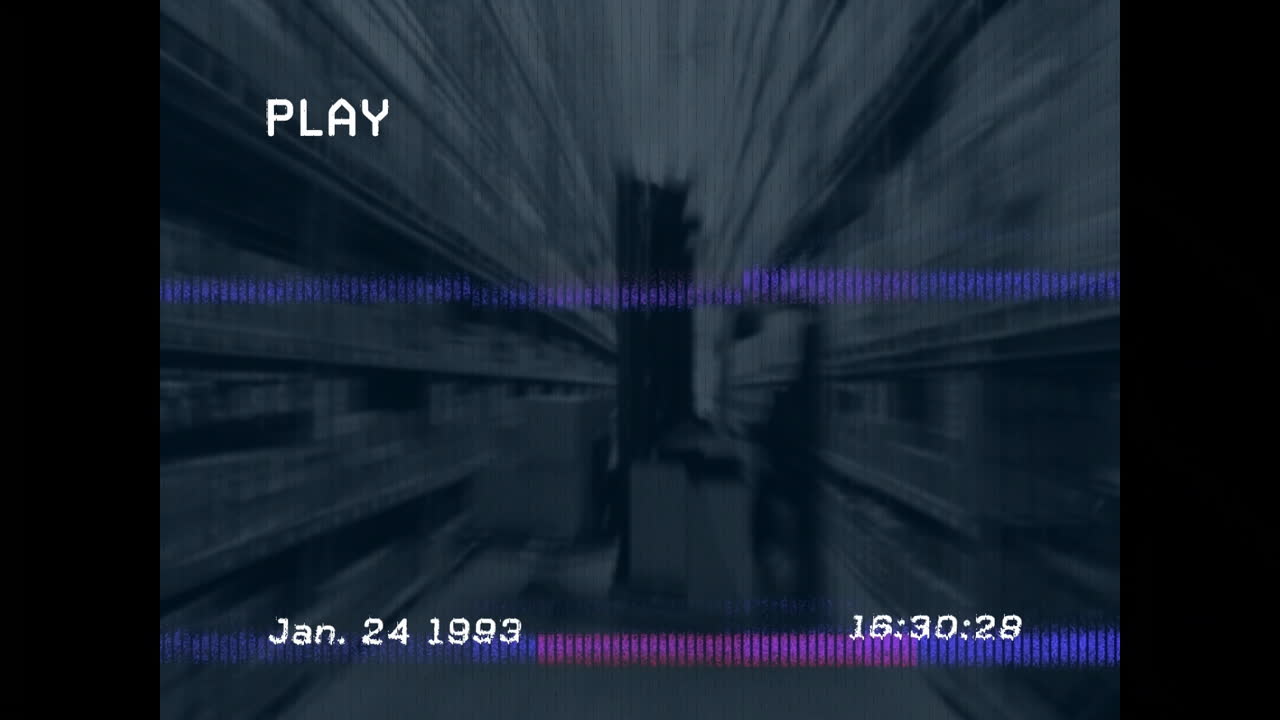In warehouse, blurred aisle with timestamp and PLAY text overlay, showing animation
