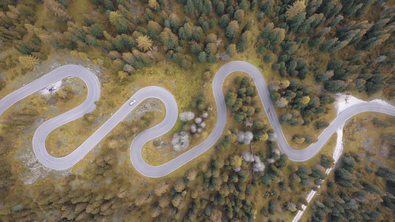 4K Aerial cinematic shot of the Dolomites famous Snake Road with vibrant fall colours. Italy_01