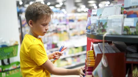 buying stationery for school. boy buying school supplies, back to school