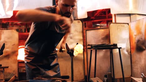 glassblower shaping a molten glass