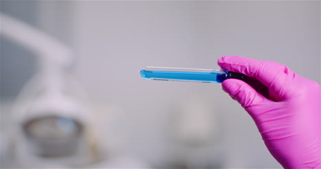 researcher holding covid 19 sample tube in hand 7