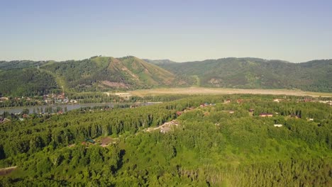 Aerial-Flying-over-the-mountains-during-sunset-Also-visible-coniferous-and-deciduous-forest