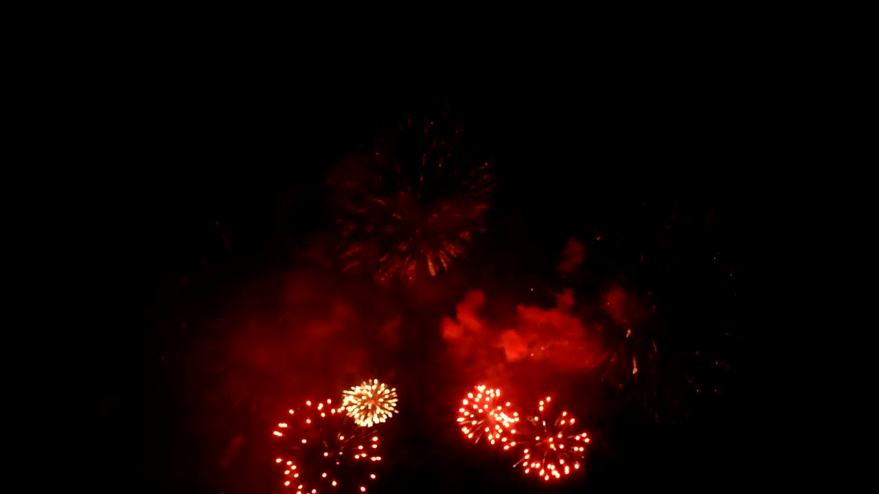 4K. loop seamless of real fireworks background. abstract blur of real golden shining fireworks with bokeh lights in the night sky. glowing fireworks show. New year's eve fireworks celebration