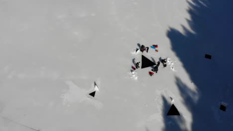 divers entering a frozen lake in the pyrenees