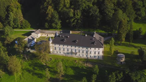 an aerial shot of the bukovje manor in the town of dravograd in slovenia