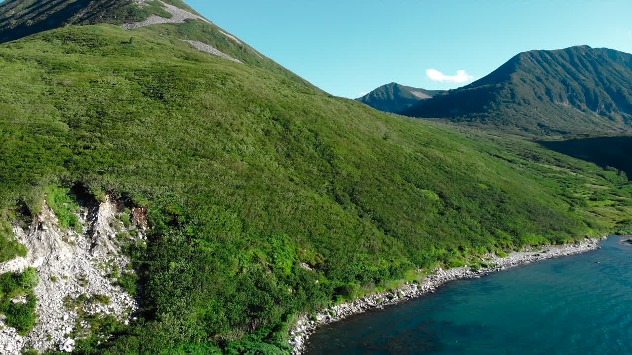 Green mountain landscape with water
