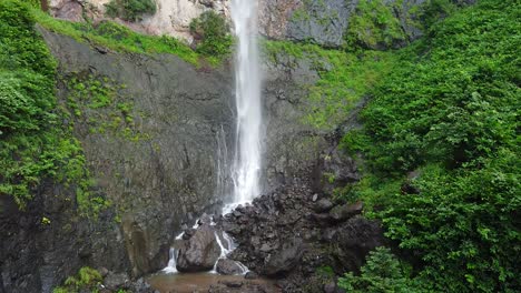 drone shot of beautiful waterfall on the hill