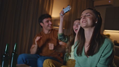 emotional girls playing video game on home couch with happy friends close up.
