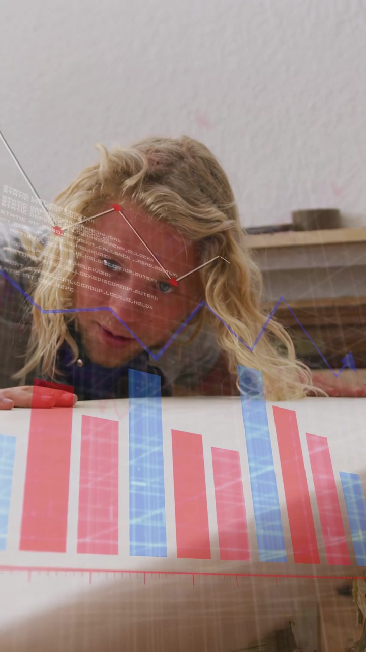 Vertical video: Man leaning over frosted sheet studying bars activating moving line nodes for data