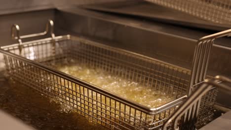 french fries cooking in hot bubbling oil