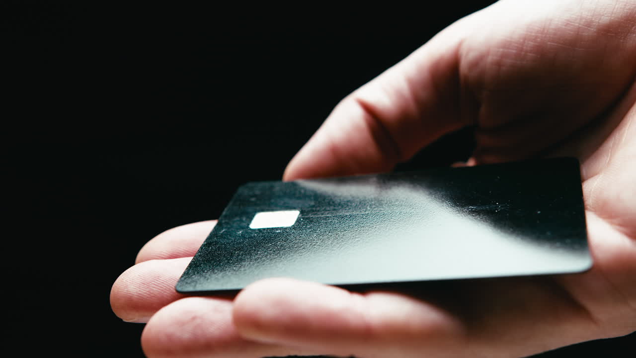 Black Friday credit card held by a man on black background