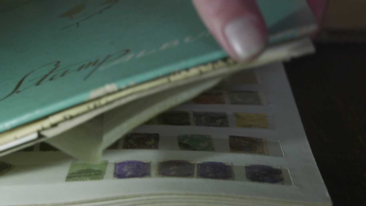 Closing an antique stamp album book in a grungy room.