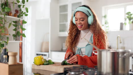 woman cooking and enjoying music