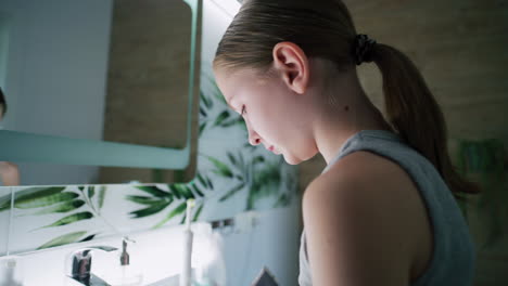 girl brushing her teeth in the bathroom