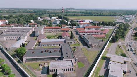 zoom out aerial view showing layout and central court of a correctional facility in czech republic.