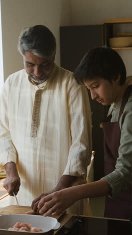 father and son cooking together in the kitchen