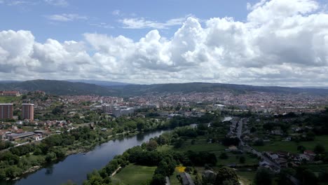 aerial pan towards ourense and mino river on beautiful sunny day, cloudy sky