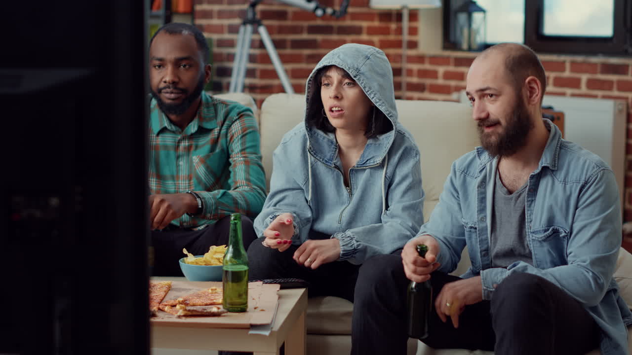 Group of friends enjoying comedy movie on tv channel program