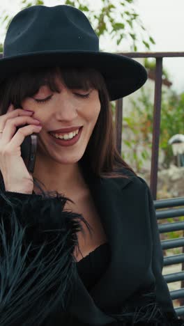 woman in elegant dress on the park bench having a call with a friend