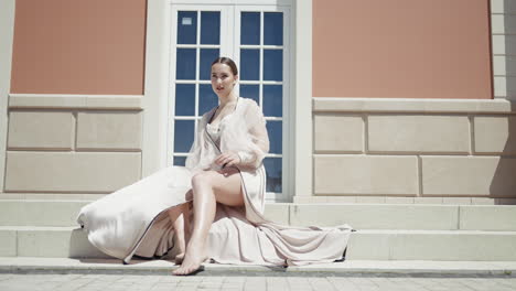 woman in a beige dress on steps