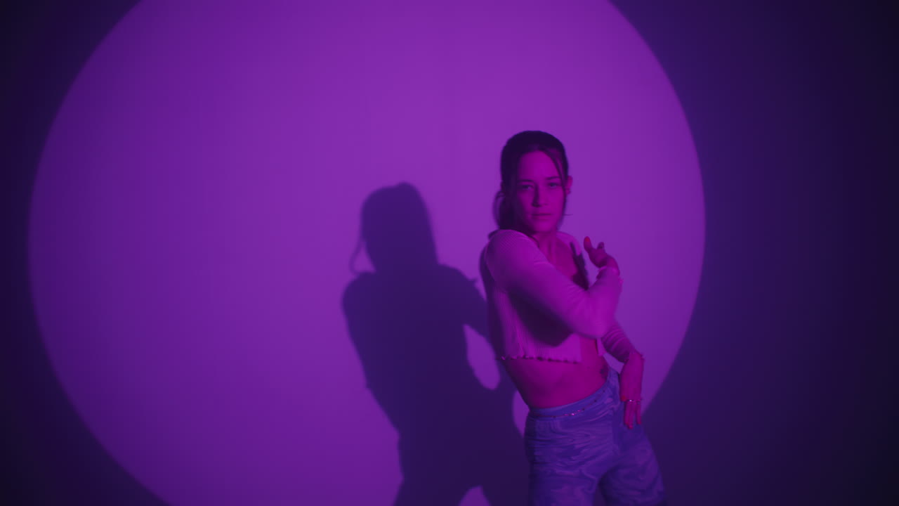 Woman Dancing in Purple Light