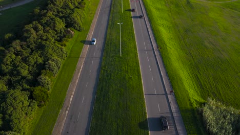 aerial view of a road with cars and people walking
